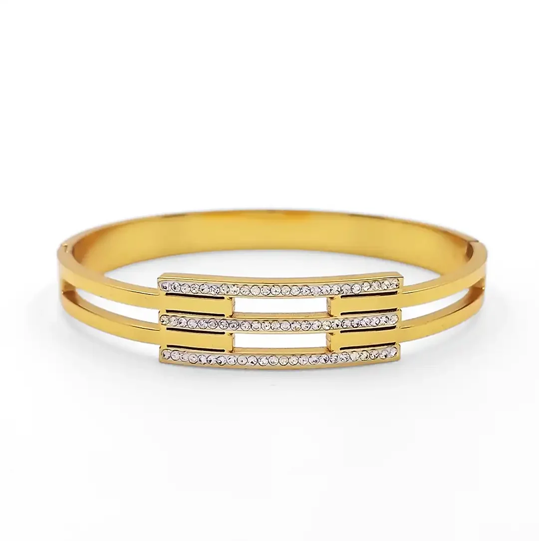 “Elegant gold-plated bracelet with triple-row CZ stone design”