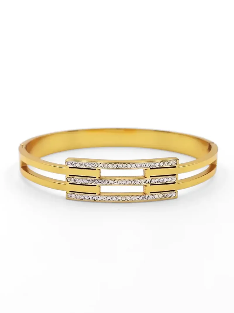 “Elegant gold-plated bracelet with triple-row CZ stone design”
